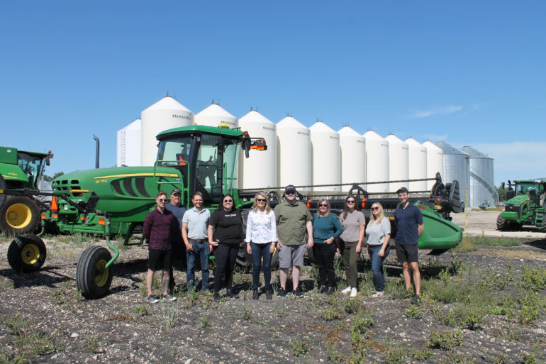 EMILI staff standing in front of combine